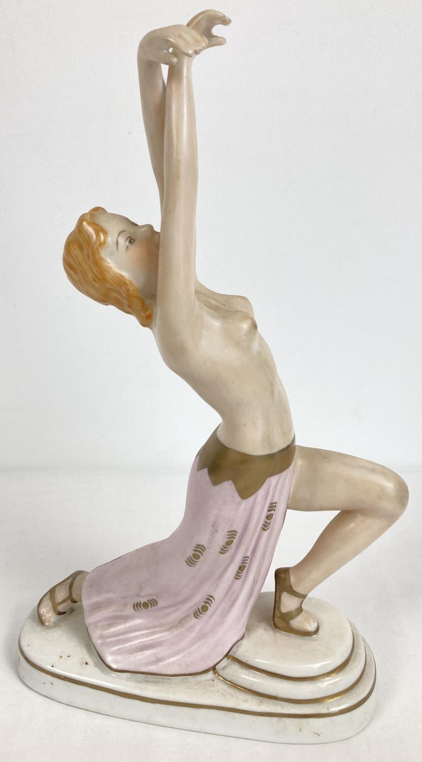 An Austrian Wien porcelain semi nude figurine of a dancer in an Art Deco style. With gilt detailing.