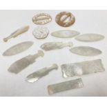 A small collection of antique mother of pearl counters, buckles and a button. Counters in fish and