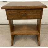 A mid Century Brandt Ranch Oak single drawer occasional stand with rough hewn design carved into
