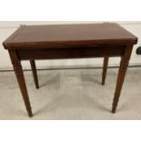 An Edwardian fold out mahogany table with pull out support legs to back revealing a hidden draw. Tan