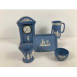 5 items of Wedgwood blue & white jasper ware. To include: 9" Millennium mantel clock, 5" jug with