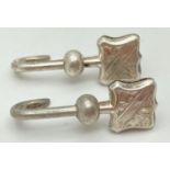 A pair of Art Deco silver napkin hooks with engraved detail to clips. Both hallmarked W.H. Collins &
