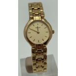 A ladies gold tone bracelet strap wristwatch by Tissot. Pale gold face with gold tone hour markers