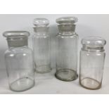 4 large antique apothecary jars with dome style lids. Largest approx. 41cm tall.