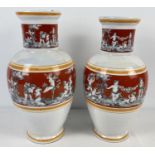 A pair of vintage ceramic vases with lustre glaze and panelled design depicting cherubs. Of