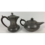 An Arts and Crafts matching pewter teapot and water pot with hammered design and stud detail. Marked