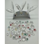 A collection of loose small Swarovski crystal flowers and hearts together with a silver arch stand