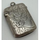 A late Victorian silver vesta case with engraved foliate & scroll detail front & back. Fully