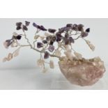 A wire, amethyst and rose quartz bonsai tree. Leaves are made from small pieces of rose quartz and