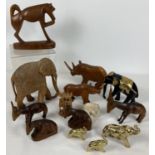 A collection of mostly wooden vintage animal figures. To include elephants, antelope and rhino.