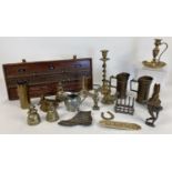 A collection of mixed vintage metal wear to include measuring jugs, candlestick, toast rack, bells