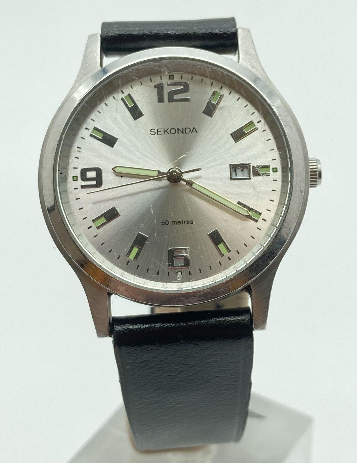 A men's Sekonda wristwatch with stainless steel case and black leather strap. Silver tone face