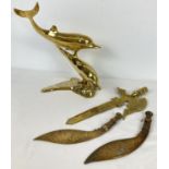 3 ornamental brass Eastern style knives together with a large brass dolphin ornament. Dolphins