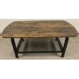 A modern black metal coffee table with wood effect top and mesh metal undershelf. Approx. 46 x 110 x