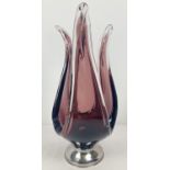 A large vintage art glass aubergine coloured dish, raised on a stainless steel foot. Approx. 41cm