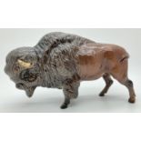 A Beswick ceramic bison figure #1019 in brown gloss finish, with circular backstamp. Approx. 13.