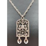 A vintage silver Welsh love spoon pendant with bell, wheel and grape detail, on a 30" white metal