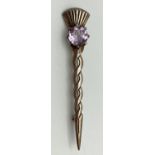 A vintage silver brooch with Celtic twist stem and thistle detail to end. Set with a round cut