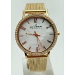 A ladies Skagen, Denmark slimline wristwatch with mother of pearl face and gold tone mesh strap.