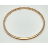 A large 9ct gold metal core bangle. Markers initials and "9ct Gold Metal Core" marked to inside.