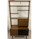 A mid 20th century design room divider by G-Plan. With four shelves in varying sizes, a cupboard