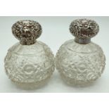 A pair of antique cut glass, silver topped perfume bottles of globular form. Decorative bottle