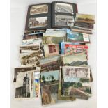 A box of assorted vintage postcards in both an album and loose. To include 1920's seaside resorts,