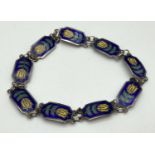 A vintage Siam silver 9 panel enamel set bracelet with yellow flower decoration. Push clasp with "