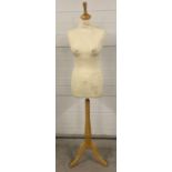 A full size clothes mannequin with tripod light wooden stand. Adjustable height.