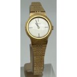 A vintage ladies 10 Microns gold bracelet style wristwatch by Tissot. Brushed silver tone face