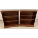 A pair of modern mahogany coloured book shelves with inlaid detail to tops. Each with 2 adjustable