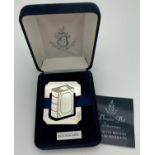 A boxed silver bookmark with engraved decoration in the shape of a book. By Douglas Pell Silverware.