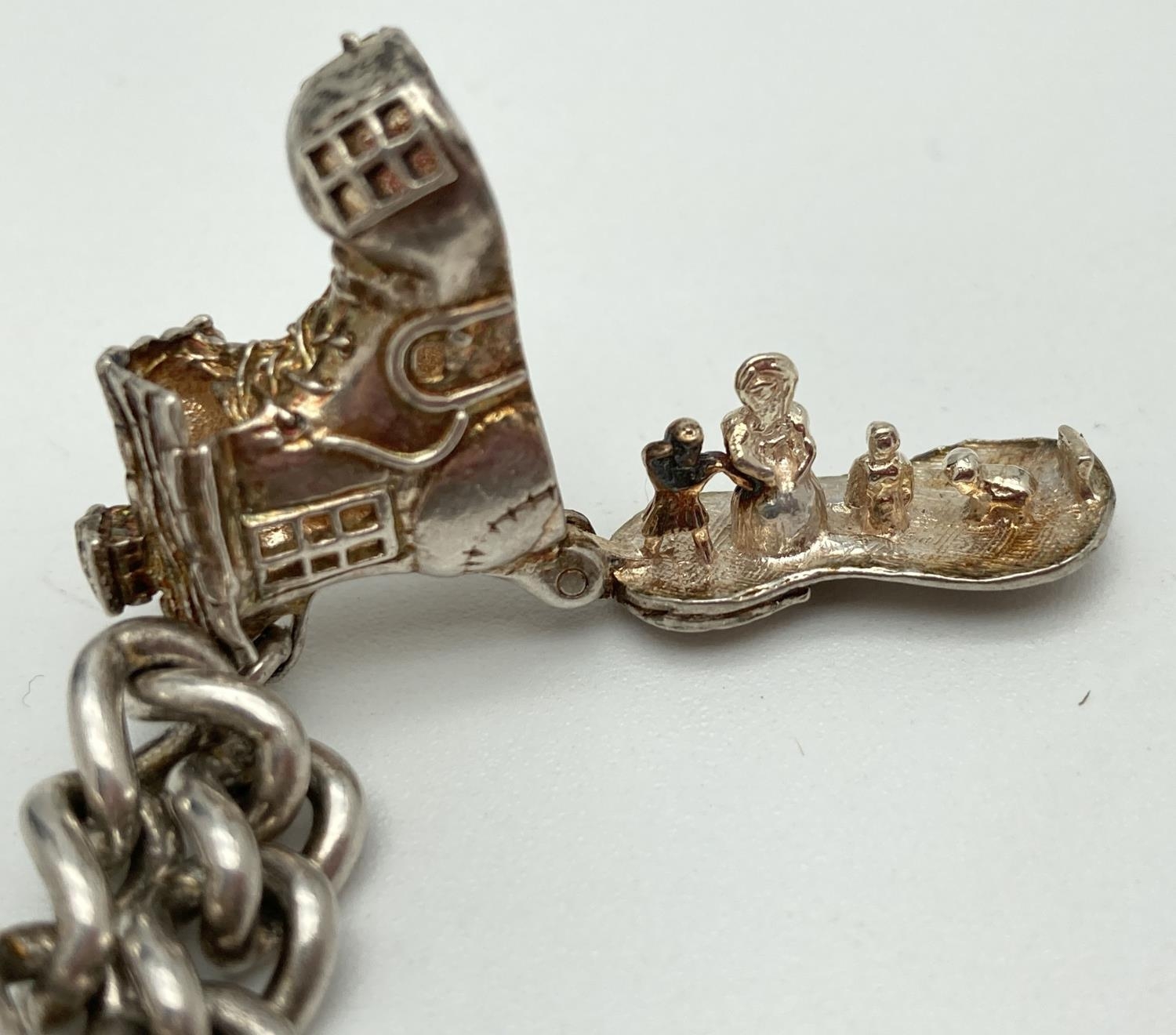 A vintage silver charm bracelet with padlock clasp, safety chain and 7 silver and white metal - Image 3 of 4
