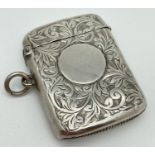 A large Edwardian silver vesta case with engraved scroll & foliate design to both sides. Front