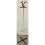 A Retro Atomic style black metal coat stand with red plastic ends and figure of 8 umbrella