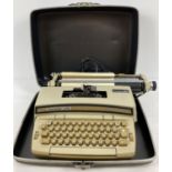A vintage Coronet Super 12 SCM Smith-Corona electric typewriter with hard carry case.