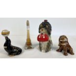4 vintage novelty alcohol decanters. A Hasta Un Decilitro dog holding a bag, A glass Eiffel Tower