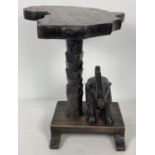 A vintage African tribal art carved lamp stand/small table. In the shape of an elephant and palm