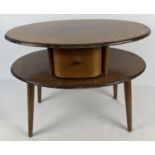 A mid 20th Century design small oval coffee/side table with shaped pull out draw and screw in