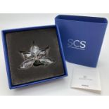 A boxed 2013 Swarovski Crystal Society 2013 renewal crystal Orchid. Complete with outer sleeve and