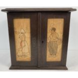 A vintage wooden tobacco cabinet with painted Dutch scenes to front. With interior draws, pipe