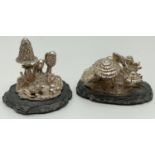 2 miniature cast silver mythical scenes featuring pixies & toadstools, mounted on slate bases.