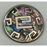 A 925 Mexican silver circular brooch/pendant with Aztec style design, set with Paua shell. Brooch