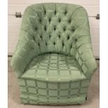 A vintage wooden framed nursing chair with bucket style seat. Reupholstered in a green chenille