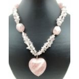 A modern design rose quartz necklace with large fixed heart shaped rose quartz pendant. Silver