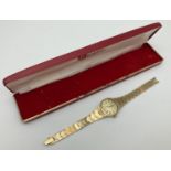 A ladies vintage gold tone bracelet wrist watch by Roamer. Oval shaped brushed pale gold face. In