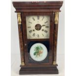 An antique Seth Thomas American weight driven mantel clock housed in a dark wood veneer case.