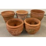 A collection of 5 terracotta garden pots in varying sizes and designs.