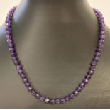 A 16" faceted amethyst beaded necklace with 9ct gold lobster claw clasp.
