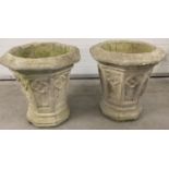 A pair of large octagonal shaped stone planters with quatrefoil panel detail.